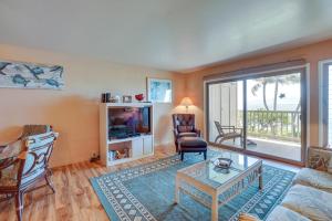 a living room with a couch and a table at Kaunakakai Condo with Private Lanai and Ocean Views! in Kaunakakai