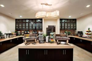 a large kitchen with two barber chairs and a counter at Homewood Suites by Hilton Fort Worth West at Cityview in Fort Worth