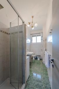 a bathroom with a shower and a toilet and a sink at RESIDENZA ERES EUR in Rome