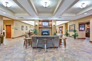 a lobby of a hotel with chairs and a fireplace at Homewood Suites by Hilton Fayetteville in Fayetteville