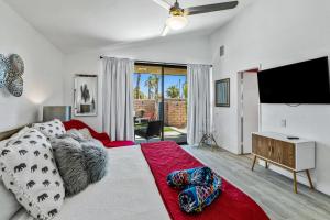 a bedroom with a bed and a flat screen tv at North De Anza Manor Permit# 615 in Palm Springs
