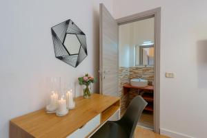 a dining room with a table with candles and a mirror at Bissenti Rooms - Eja Sardinia in Cagliari