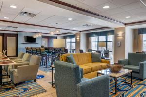 a lobby with couches and chairs and a bar at Hampton Inn Greenfield in Greenfield