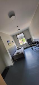 Pokój szpitalny z łóżkiem i oknem w obiekcie Hostel Nr.2 w mieście Rauna