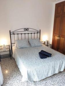 una camera da letto con un letto con un accappatoio blu sopra di Luminosa casa familiar céntrica a Marbella