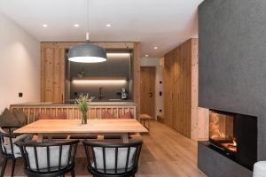 une salle à manger avec une table et une cheminée dans l'établissement Sunnseit Apartment 6, à Ultimo