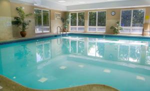 a large swimming pool with blue water in a building at Hampton Inn & Suites Greenfield in Greenfield