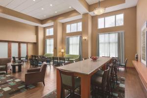 a large room with a table and chairs and windows at Hampton Inn & Suites Greenfield in Greenfield