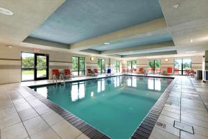 a large swimming pool in a hotel lobby at Hampton Inn & Suites Gulfport in Gulfport