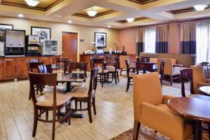 a dining room with tables and chairs in a restaurant at Hampton Inn Greensboro East / McLeansville in McLeansville