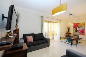 a living room with a couch and a desk with a computer at C07 - 3 Bed Luxury Penthouse in Downtown Lagos in Lagos