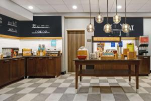 a fast food restaurant with a counter with food at Hampton Inn Greenville/Woodruff Road in Greenville