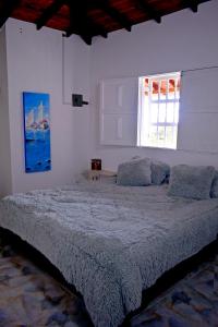 Un dormitorio con una cama grande y una ventana en Preciosa finca en el peñol de Guatapé con piscina y jacuzzi, en Guatapé
