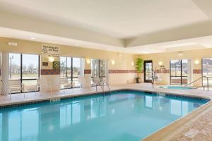 a large pool in a hotel with blue water at Hampton Inn Geneva in Geneva