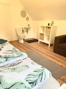 a bedroom with a bed and a sink and a toilet at Lendorfer Cottage in Feldkirchen in Kärnten