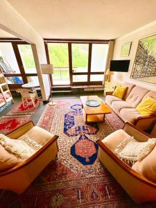 a living room with two couches and a rug at La Valette in Isola