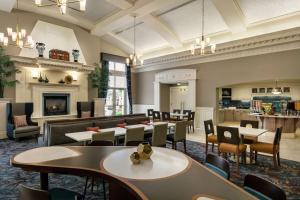 a restaurant with tables and chairs and a fireplace at Homewood Suites by Hilton Harrisburg East-Hershey Area in Harrisburg