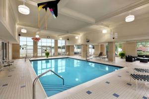 a swimming pool in a hotel lobby with a large pool at Homewood Suites by Hilton Harrisburg East-Hershey Area in Harrisburg