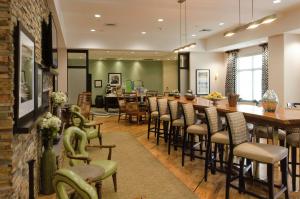 a bar in a restaurant with chairs and a counter at Hampton Inn Hickory in Hickory