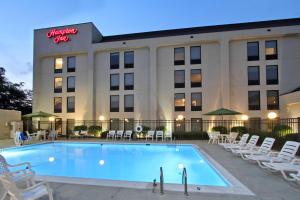 a hotel with a swimming pool in front of a building at Hampton Inn Hagerstown in Hagerstown