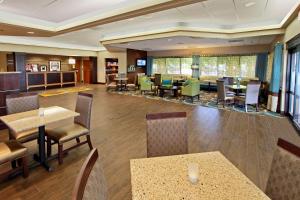 a lobby of a hotel with tables and chairs at Hampton Inn Hagerstown in Hagerstown