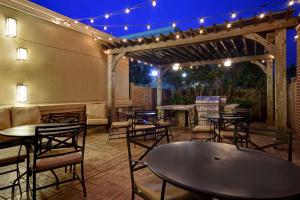 a patio with tables and chairs and lights at Homewood Suites By Hilton HOU Intercontinental Airport in Houston