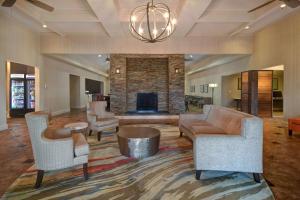 a living room with a couch and chairs and a fireplace at Homewood Suites By Hilton HOU Intercontinental Airport in Houston