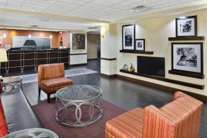 a lobby with a waiting area with furniture and a flat screen tv at Hampton Inn Hinesville in Hinesville
