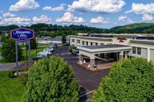 a hotel with a sign in a parking lot at Hampton Inn Ashland in Ashland