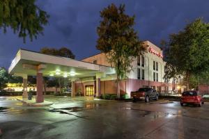 a building with a car parked in a parking lot at Hampton Inn Houma in Houma