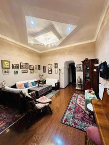 a living room with a couch and a table at Guest house tm in Tbilisi City