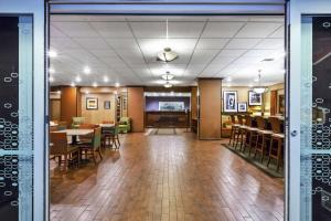a lobby with tables and chairs and a dining room at Hampton Inn Idaho Falls in Idaho Falls