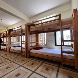 a room with four bunk beds in it at Mybhumi Resort in Malshej Ghat +36 photos