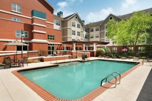 a swimming pool at a hotel with tables and chairs at Homewood Suites by Hilton Wilmington-Brandywine Valley in Talleyville