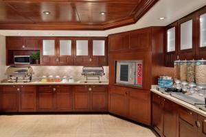 a large kitchen with wooden cabinets and appliances at Homewood Suites by Hilton Wilmington-Brandywine Valley in Talleyville