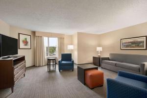a living room with a couch and a tv at Homewood Suites by Hilton Wilmington-Brandywine Valley in Talleyville