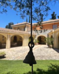 una campana colgando delante de una casa en S'Arenada Hotel - Adults Only en Villasimius
