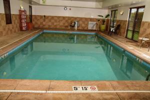 a large swimming pool with blue water in a building at Hampton Inn Indiana in Indiana
