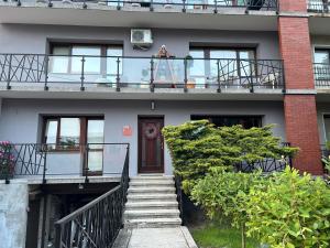 a stairway leading up to a house with a balcony at Apartament Francuzka in Kraków