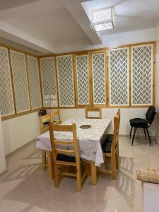 a dining room with a table and chairs at 4 Seasons Guesthouse Gafait 