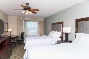 a hotel room with two beds and a ceiling fan at Homewood Suites by Hilton Indianapolis Northwest in Indianapolis