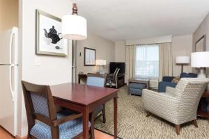 a living room with a table and chairs in a room at Homewood Suites by Hilton Indianapolis Northwest in Indianapolis +17 photos