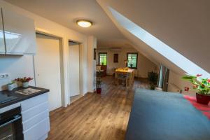 a kitchen and living room with a staircase in a house at UpArt Bled in Bled