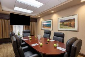 a conference room with a wooden table and chairs at Hampton Inn Winston-Salem Hanes Mall in Winston-Salem +31 photos