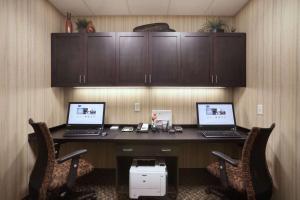 un escritorio con 2 ordenadores portátiles encima en Hampton Inn & Suites Williston en Williston