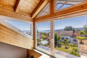 a view from inside a wooden house with windows at Haus Unterseeblick Sonnenuntergang in Gaienhofen