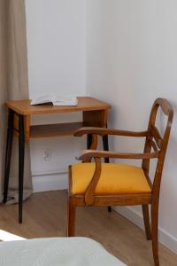 a chair sitting next to a desk with a laptop at Apartment Podwale Staromiejskie Gdańsk with Balcony by Renters in Gdańsk