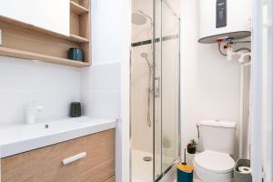 a bathroom with a toilet and a glass shower at Piton des Neiges - Nid douillet terrasse vue port in Arcachon