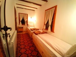 a room with two beds in a room at Villa Lyutovi Holiday Home in Koprivshtitsa