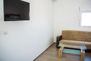 a living room with a couch and a glass coffee table at Apartments Leyla in Ulcinj